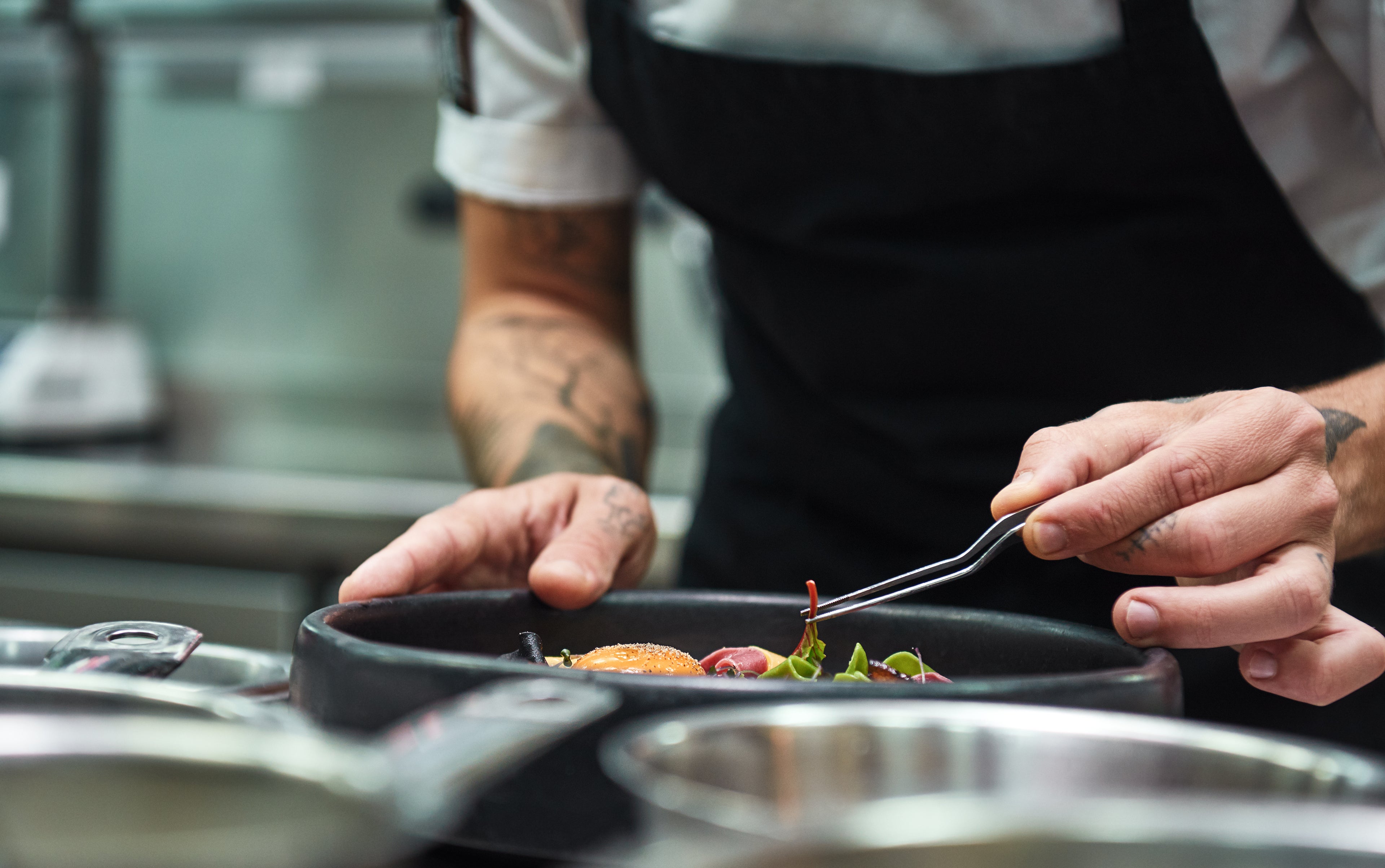 Chef preparing a dish in a professional kitchen